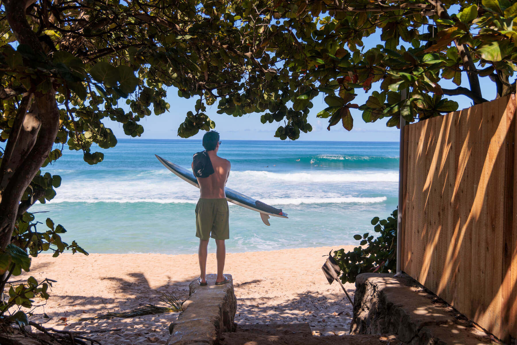 Surfer wearing Reef sandals by the beach